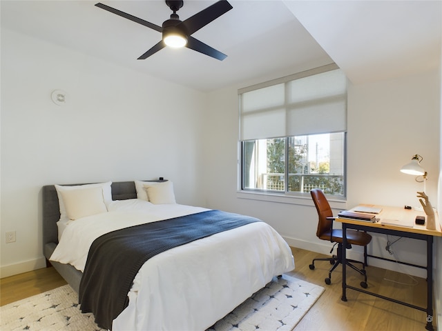 bedroom featuring ceiling fan and light hardwood / wood-style flooring