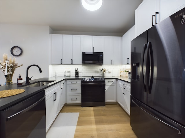 kitchen with white cabinetry, sink, backsplash, and black appliances