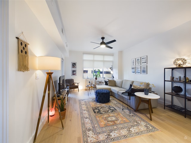 living room with ceiling fan and light hardwood / wood-style floors