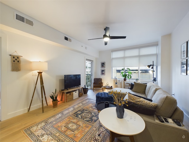 living room with ceiling fan and hardwood / wood-style flooring