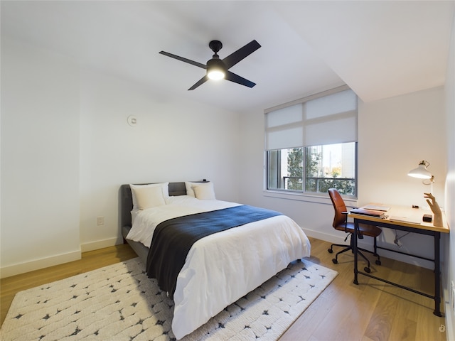 bedroom with ceiling fan and light hardwood / wood-style floors