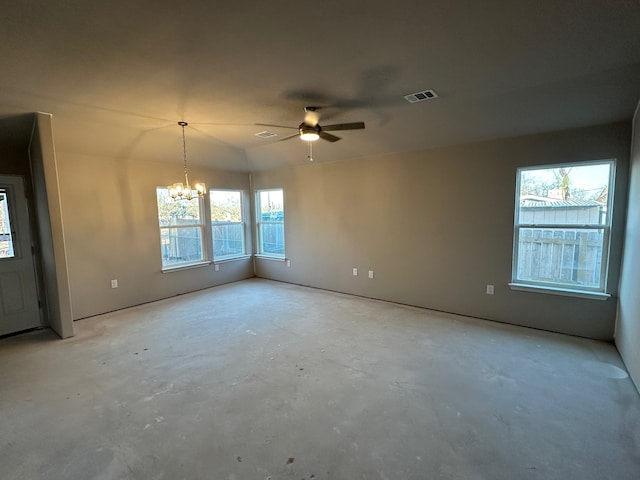 spare room featuring ceiling fan with notable chandelier