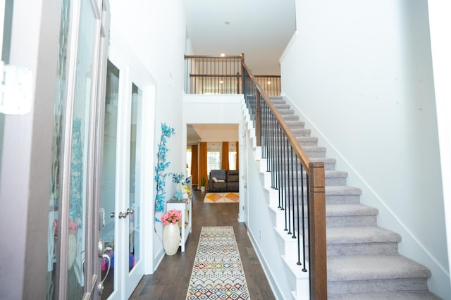 stairway featuring hardwood / wood-style flooring and french doors