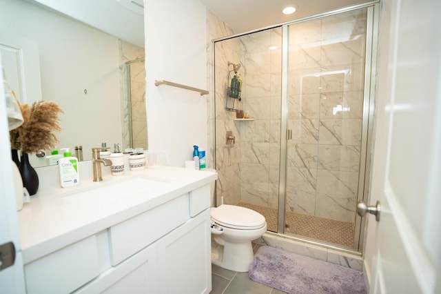 bathroom featuring a shower with shower door, toilet, vanity, and tile patterned flooring