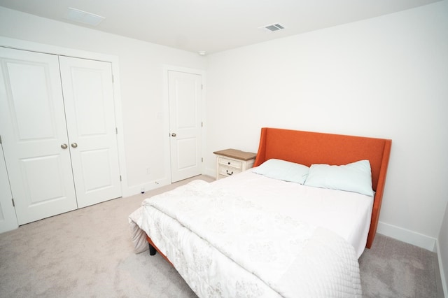 carpeted bedroom featuring a closet