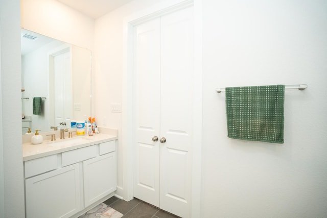 bathroom with tile patterned floors and vanity