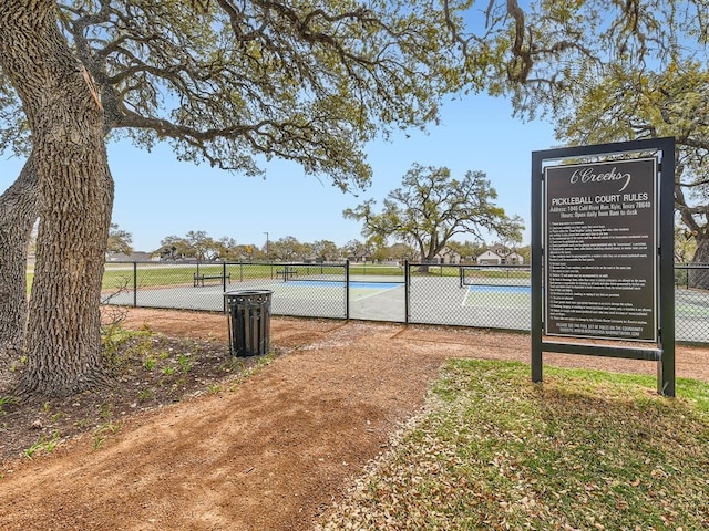 view of home's community featuring tennis court