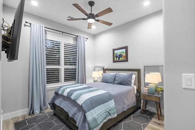 bedroom with ceiling fan and hardwood / wood-style flooring