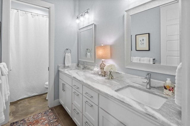 bathroom featuring toilet and vanity