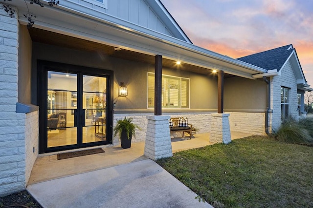 exterior entry at dusk with french doors and a yard