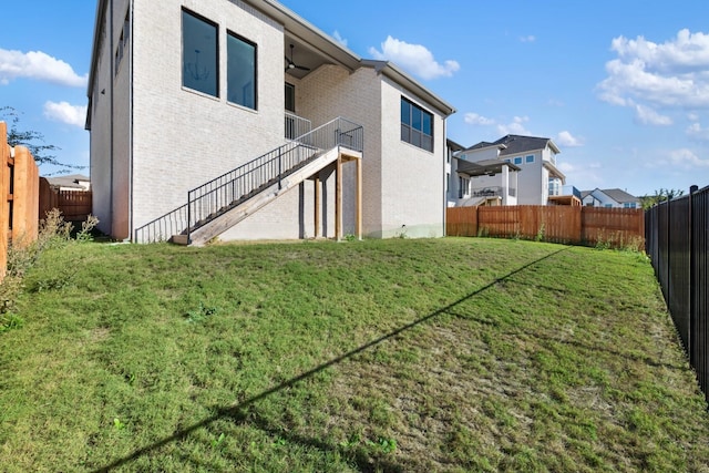 back of house with a lawn