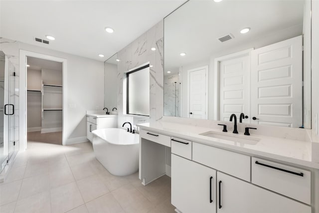 bathroom with vanity and independent shower and bath