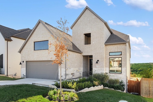 view of front of home featuring a front lawn and a garage