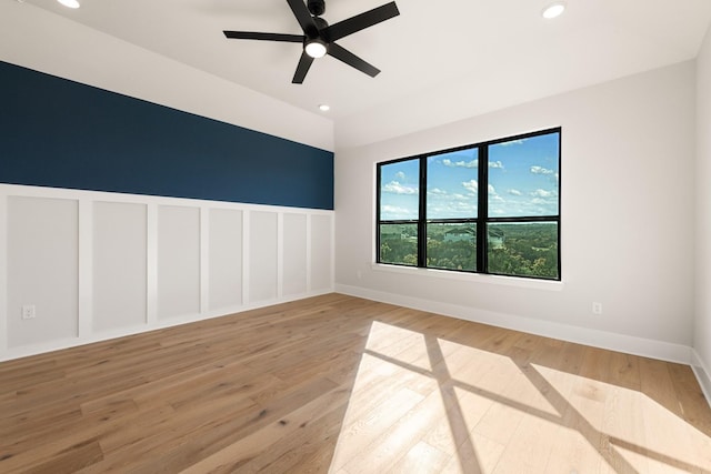 spare room featuring ceiling fan, vaulted ceiling, and light hardwood / wood-style floors