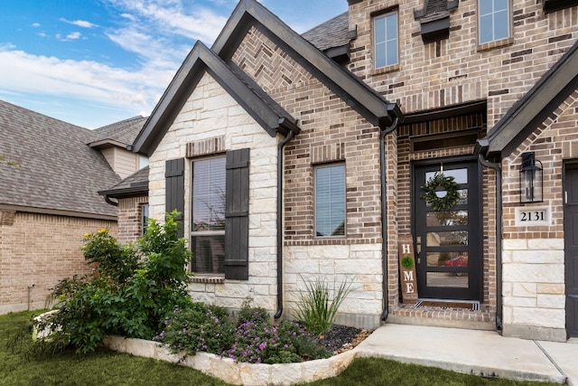2131 Thayer Cv, San Antonio, TX 78253 - property entrance featuring stone siding, brick siding, and roof with shingles