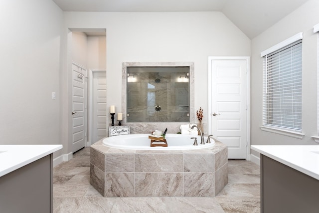 2131 Thayer Cv, San Antonio, TX 78253 - bathroom with vanity, a bath, a tile shower, vaulted ceiling, and marble finish flooring