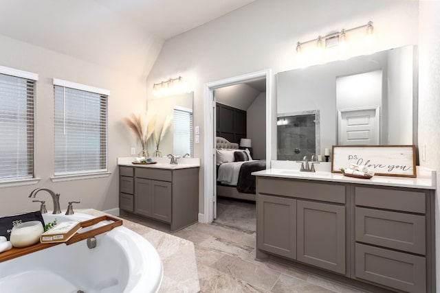 2131 Thayer Cv, San Antonio, TX 78253 - ensuite bathroom featuring two vanities, a tile shower, vaulted ceiling, and a garden tub