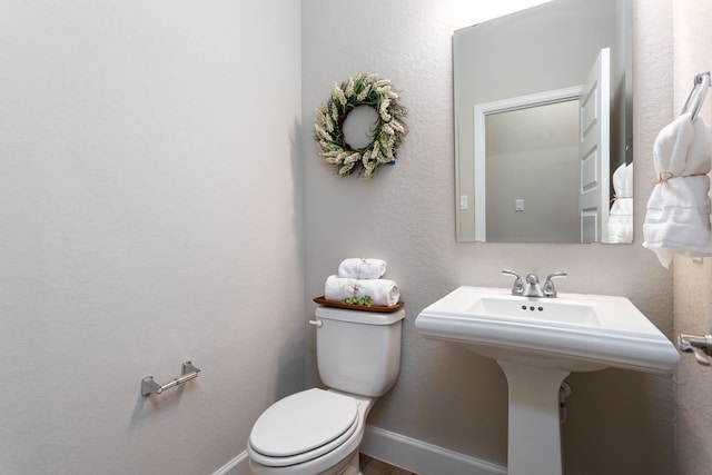 bathroom featuring toilet and sink