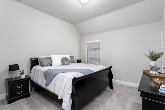 carpeted bedroom with lofted ceiling