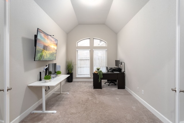 home office with light colored carpet and vaulted ceiling