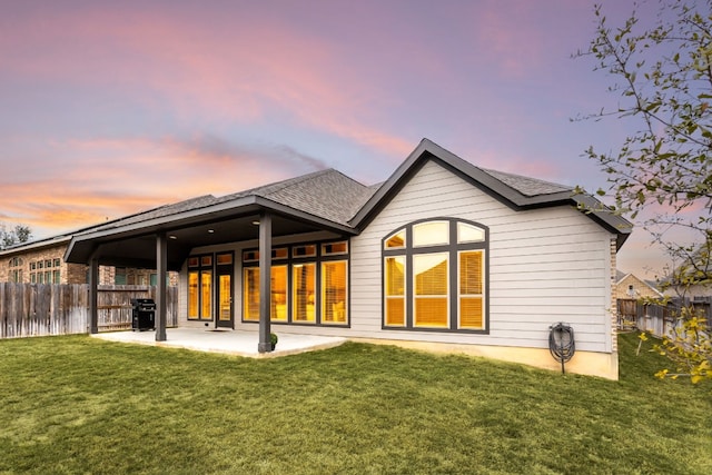 2131 Thayer Cv, San Antonio, TX 78253 - back of house at dusk featuring a patio, a fenced backyard, and roof with shingles