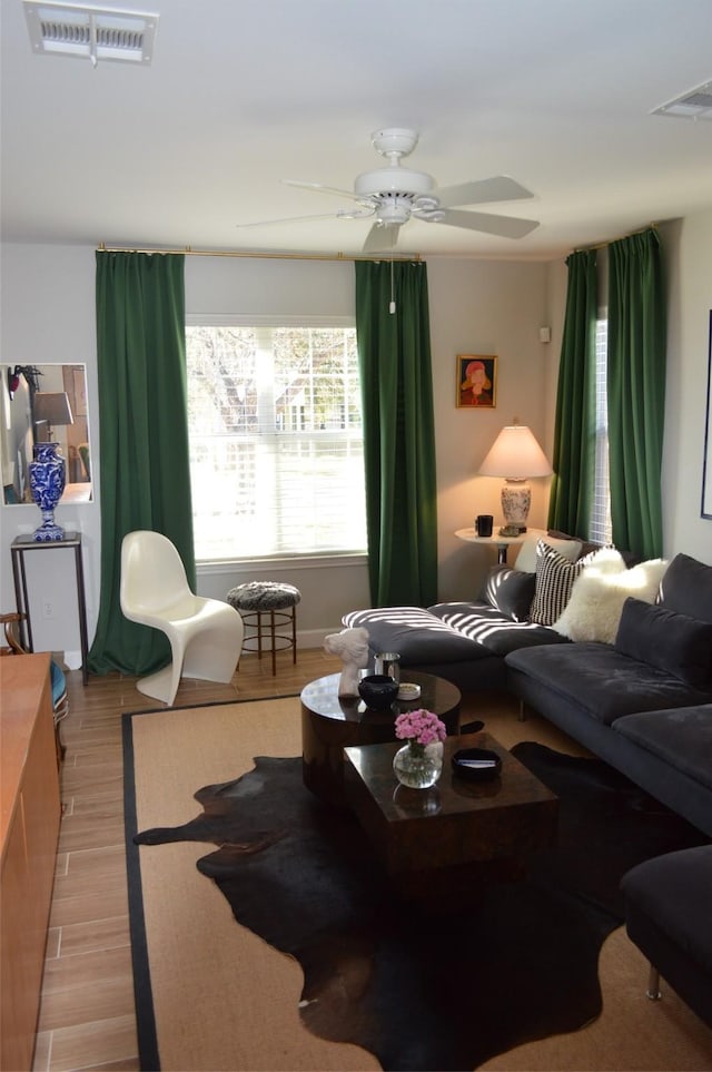 living room featuring light wood-type flooring and ceiling fan