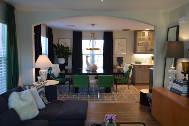 living room featuring an inviting chandelier and light hardwood / wood-style flooring