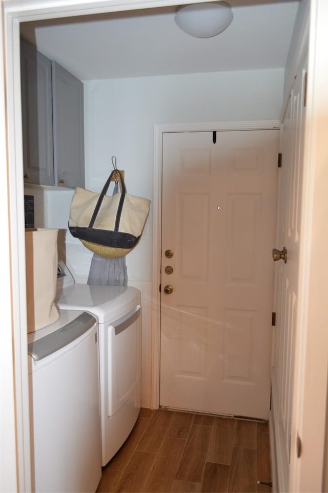 laundry room featuring washing machine and dryer and cabinets