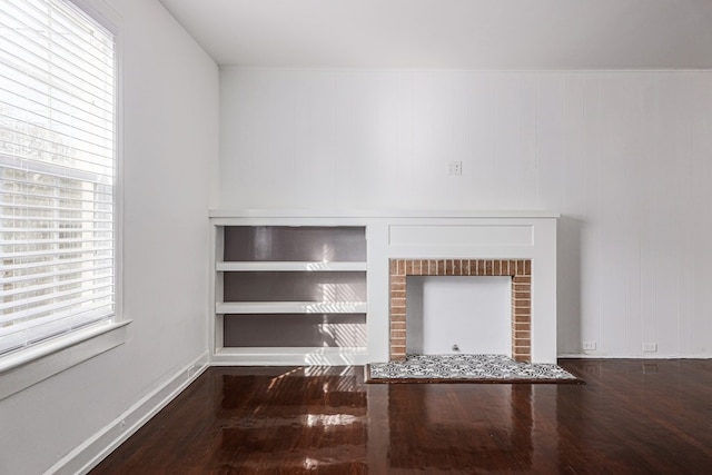 details featuring hardwood / wood-style floors, built in features, and a fireplace