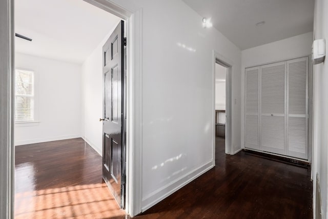 corridor with dark hardwood / wood-style floors