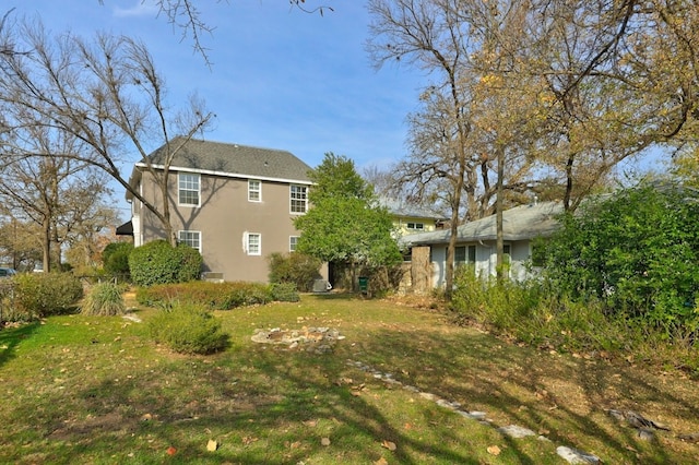 back of property featuring a lawn