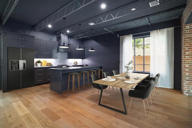 dining room with light hardwood / wood-style flooring and sink