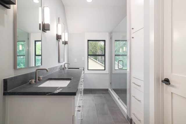 bathroom with tile patterned floors, an enclosed shower, and vanity