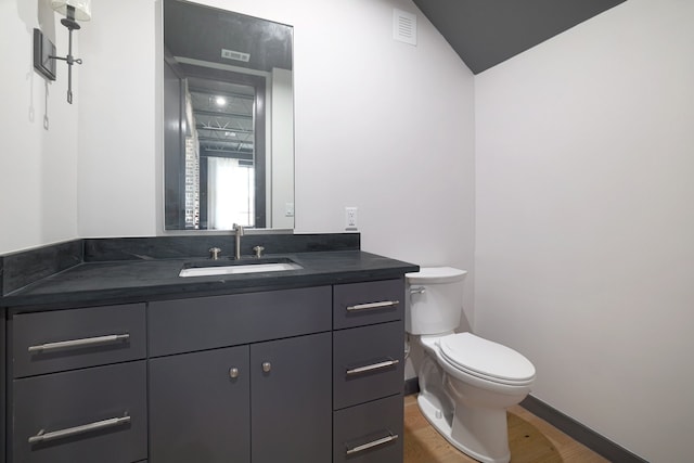 bathroom featuring toilet, hardwood / wood-style floors, and vanity