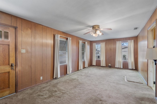 interior space featuring ceiling fan and light carpet