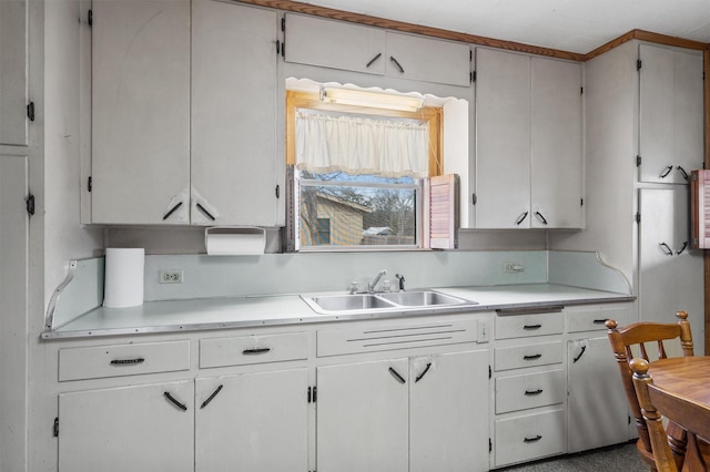 kitchen featuring crown molding, decorative backsplash, white cabinets, and sink