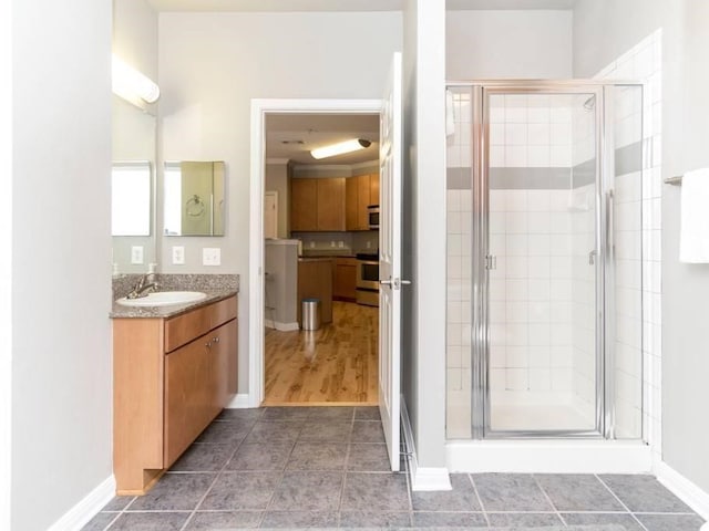 bathroom featuring an enclosed shower and vanity