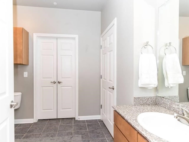 bathroom featuring toilet and vanity