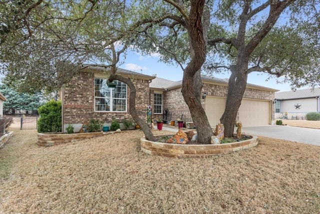 ranch-style house with a garage, brick siding, driveway, and fence