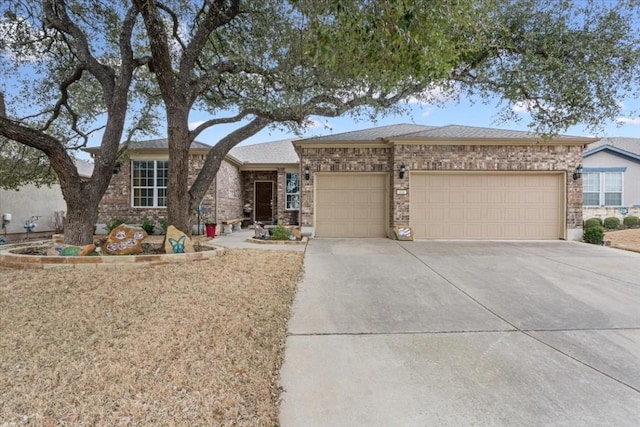 ranch-style home featuring a garage, driveway, and brick siding