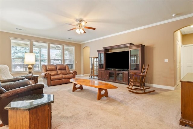 living room featuring arched walkways, ornamental molding, light carpet, and baseboards