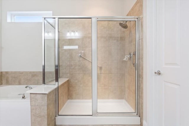 full bathroom with a garden tub and a shower stall