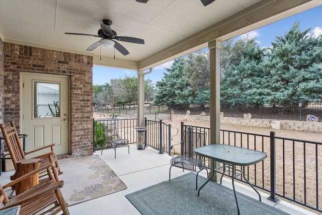 view of patio featuring fence and a ceiling fan