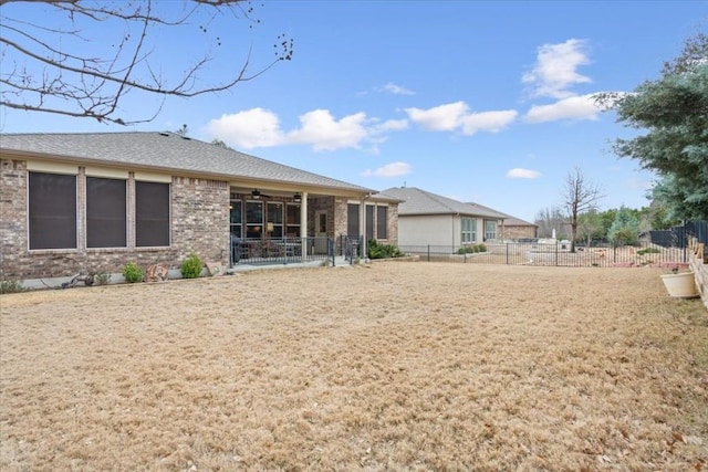 back of house with brick siding and fence