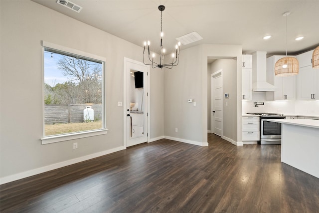 kitchen with white cabinets, stainless steel range oven, premium range hood, and pendant lighting