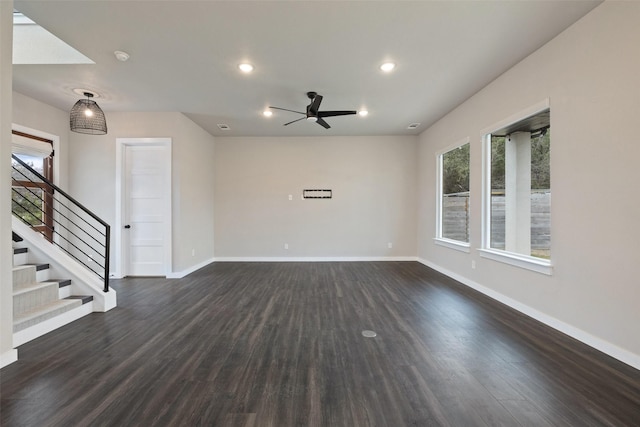 unfurnished room featuring dark wood-type flooring and ceiling fan