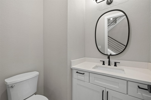 bathroom featuring toilet and vanity