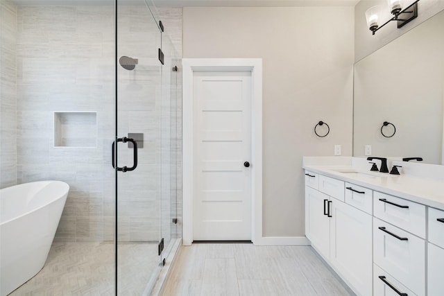 bathroom with vanity and shower with separate bathtub