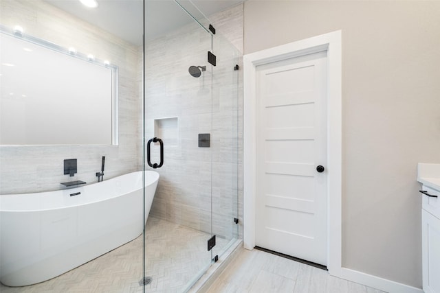 bathroom with separate shower and tub, vanity, and tile patterned flooring