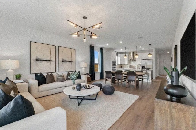 living room featuring a chandelier and wood-type flooring